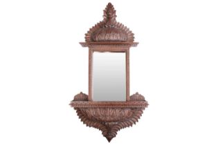 An Anglo-Indian carved wood mirror, the rectangular glass over a lower shelf, 94 cm x 49 cm First