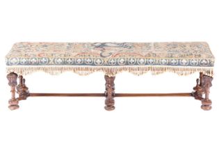 A late seventeenth-century style walnut long hearth stool, early twentieth-century with