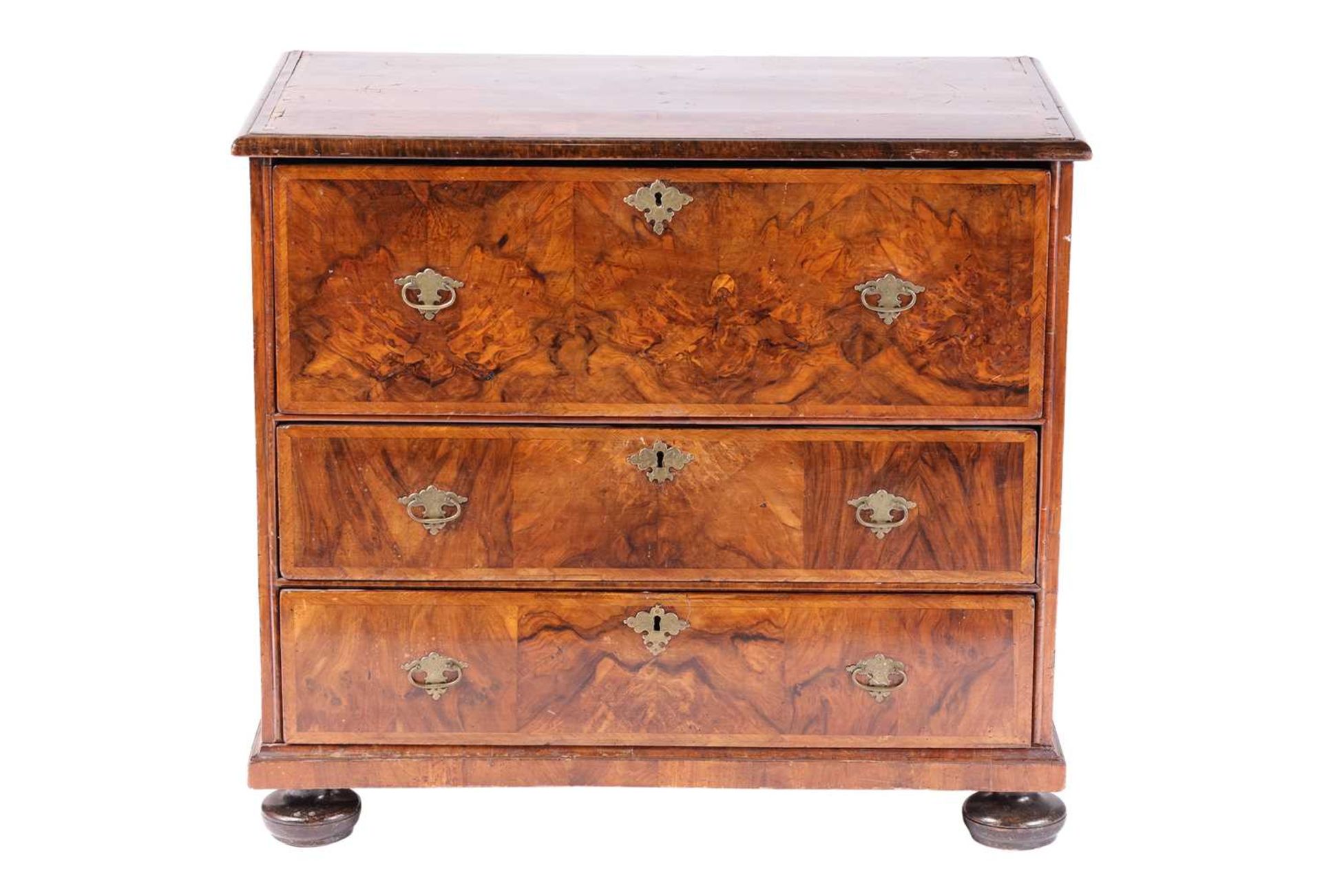 A William & Mary walnut chest of three long drawers, the parquetry top with the central quartered