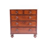 A nineteenth-century mahogany miniature chest of two short over three long drawers, terminating on