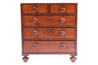 A nineteenth-century mahogany miniature chest of two short over three long drawers, terminating on