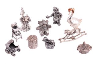 A collection of nursery-themed miniature figures and items, comprising a silver Jemima Puddle-Duck