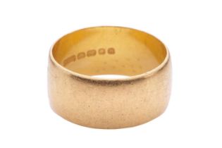 A wedding band in 22ct yellow gold, in a wide plain shank, London hallmarked 1968, size Q, width 9.2