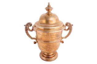 A large silver gilt trophy cup and cover. Known as The Barratt Cup. Inverted bell shape with