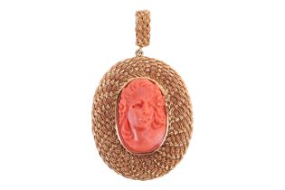 A 19th century carved coral pendant, depicting a profile portrait of a maiden, bezel set in a