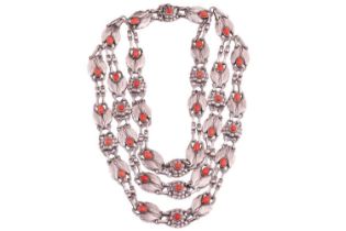 Georg Jensen - a triple-strand floral necklace set with coral, comprising repoussé links in the form
