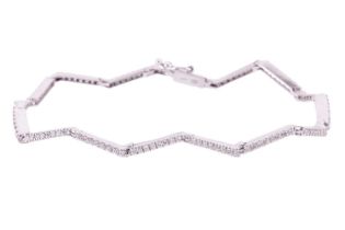 A diamond line bracelet of zig-zag design, a series of articulated link pavé-set with 128