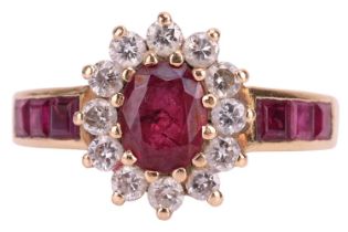 A gem-set floral cluster ring, the centrally set garnet topped doublet surrounded by twelve round