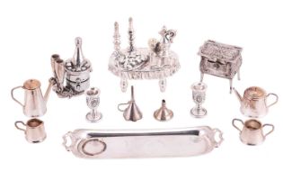 A collection of miniatures comprising a silver four-piece tea and coffee service on a tray, two