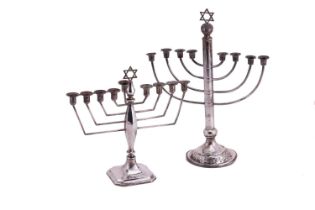 A silver menorah with curved branches and columnar stem; to an engraved domed circular base.