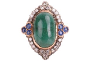 An emerald, diamond and sapphire cocktail ring, the lozenge-shaped ring head centred with a large