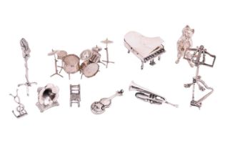 A collection of musically themed miniature figures, comprising a silver gramophone by Harrison