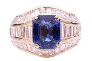 A sapphire and diamond dress ring, the emerald cut sapphire measuring 9.3 x 7.6 x 4.2mm, within
