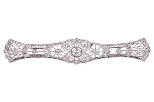 A diamond-set filigree bar brooch featuring thirty-five transitional cut diamonds, the largest