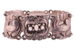 Georg Jensen - a plaque link bracelet with dove and foliate design, formed with repoussé links