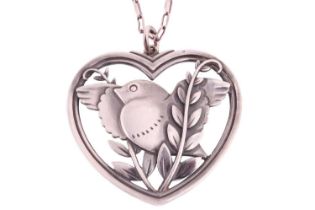 Georg Jensen - a heart-shaped pendant on a chain depicting a flying dove with olive branches, loop