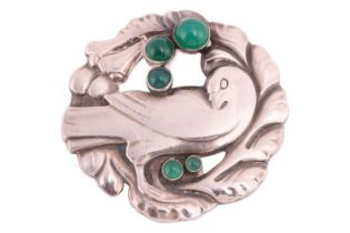 Georg Jensen - a circular brooch depicting a dove in wreath with chrysoprase cabochon accents,