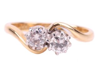 A diamond-set toi et moi ring, each round brilliant diamond claw set in a white metal setting,