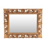 An 18th-century style heavy framed rectangular wall mirror with carved pierced and gilt scrolled