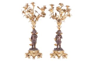 A pair of French ormolu and bronze figural six-sconce candelabra in the manner of Auguste Moreau a
