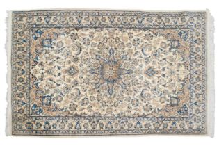 An ivory ground Nain rug with formal bookcover design, within palmette borders. 191 cm x 121 cm A