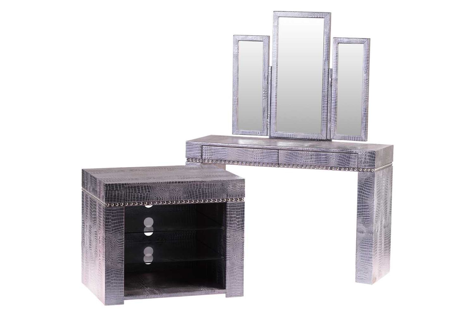 A contemporary 'brutalist' faux iridescent crocodile skin-covered dressing table with a triptych
