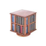An Edwardian satinwood miniature revolving bookcase, containing a miniature set of Shakespeare