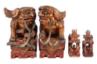 A large pair of Chinese red lacquered and parcel-gilt wood architectural Dog of Foo finials,