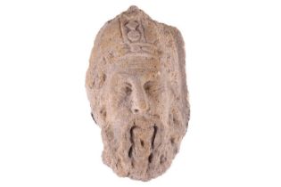 A European carved stone architectural fragment; probably a 15th-century corbel carved as the head of