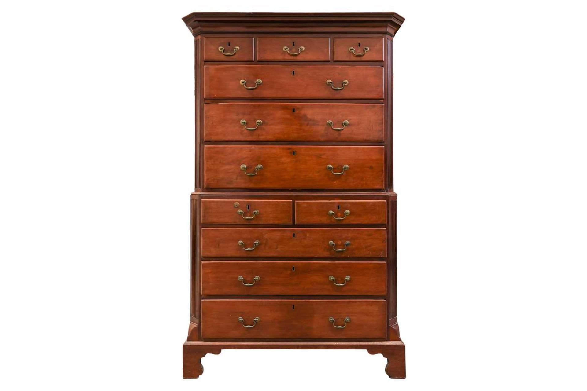 A George III mahogany chest on chest with canted and fluted corners, the upper carcass with three