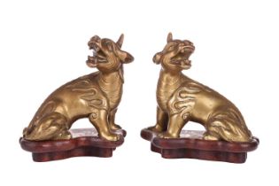 A pair of Chinese, gilt bronze scholar's scroll weights, in the form of seated Pixue, Qing