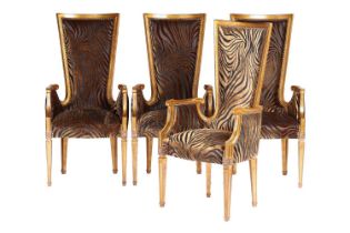 A set of four carved and giltwood 'Hollywood Louis' style high backed armchairs with gold flake