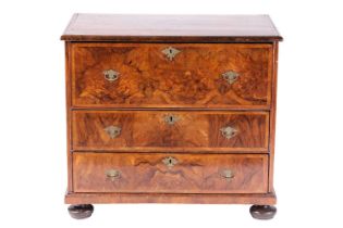 A William & Mary walnut chest of three long drawers, the parquetry top with the central quartered