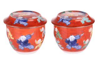 A pair of Chinese Famille Verte porcelain tea bowls and covers, 20th century, painted with coral red