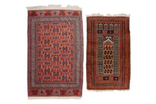 A red ground Turkoman rug with rows of composite guls within multiple borders and rams horn ends,