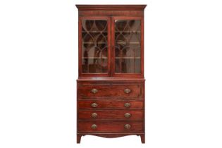 A George IV mahogany secretaire bookcase, the upper section with a pair of eliptical glazed doors,