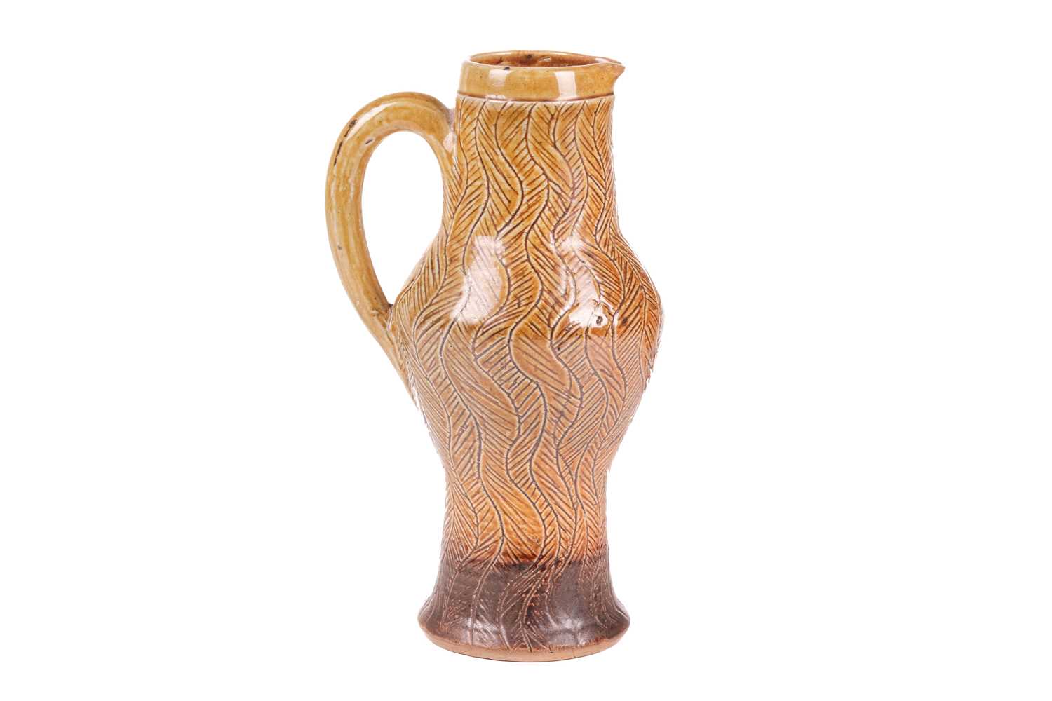 A late 19th-century Martin Brothers stoneware tall jug, of bellied form with incised vertical wavy