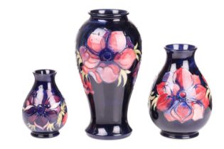 A large Moorcroft baluster vase in the Anenome pattern, tube-lined decoration on a dark blue ground,