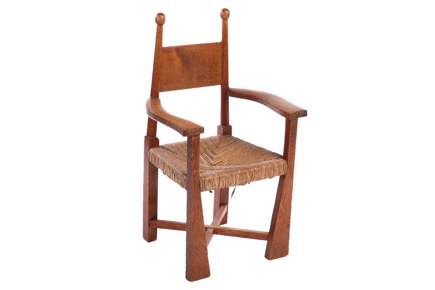 An Arts & Crafts oak rush-seated child's chair, probably designed by E.J. Punnett for William
