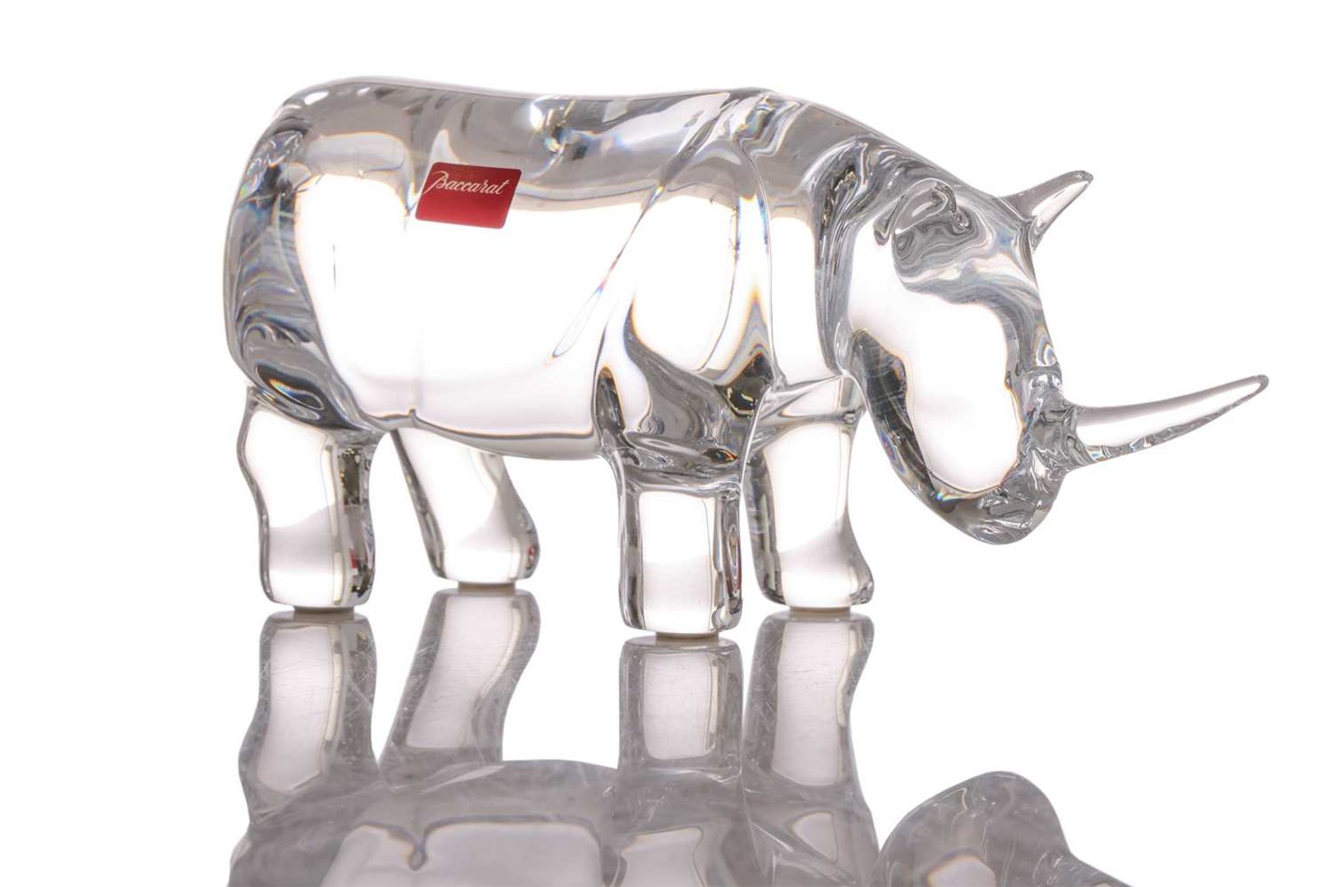 A Baccarat crystal glass figure of a rhinoceros, 8.5 cm x 18.5 cm, in original box.