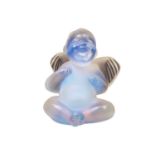 A contemporary Lalique opaline crystal glass paperweight, modelled as a seated cherub / putti, 7.5