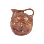 A large Martin Brothers stoneware grotesque face jug, by Robert Wallace Martin, each side