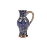 A late 19th century Martin Brothers stoneware jug, of bellied form with mottled blue glaze on a