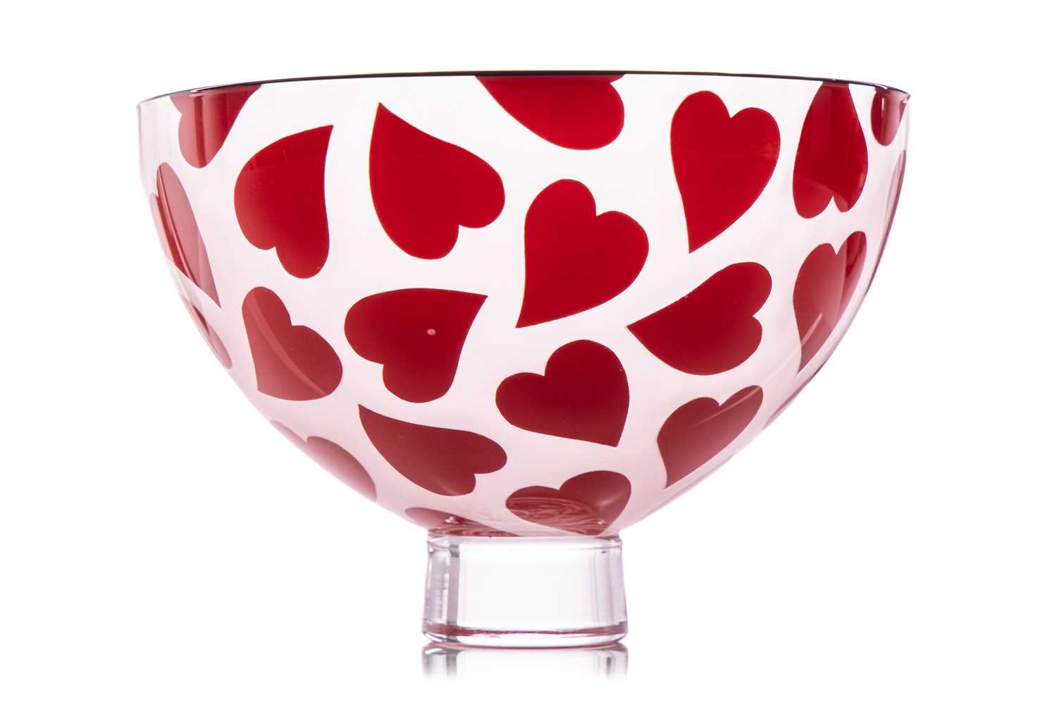 A Gillies Jones art glass bowl, with red heart decoration on a circular foot, etched signature to