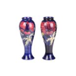 A near pair of Walter Moorcroft tall vases, in the Anenome pattern, tube-lined decoration on a