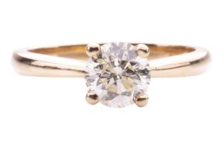 A diamond solitaire ring in 18ct yellow gold, claw-set with a round brilliant-cut diamond of 6.4 mm,