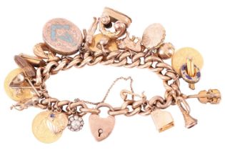 A 9ct gold charm bracelet, suspending 22 various charms. The curb link chain terminates with a 9ct