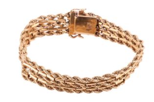 A textured chain bracelet, comprised of five alternating rows of connected rope and bar link chains,