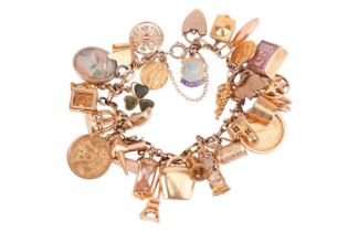 A charm bracelet in 9ct gold, with a variety of charms including two half sovereigns; Edward VII,