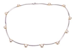 A diamond-set link necklace, featuring eleven round brilliant-cut diamonds, graduated in size with a
